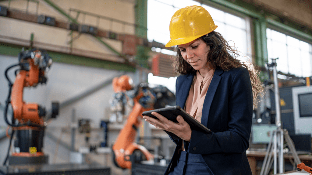 Female engineering manager inside a factory working on a tablet
